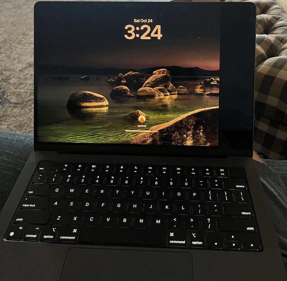 MacBook Pro lock screen with a dark dead strip along the right edge